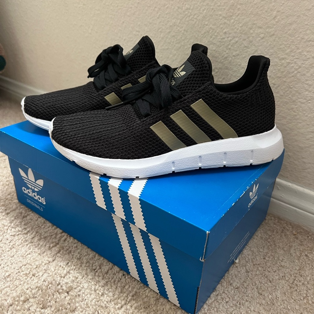 Adidas black, white, and gold SWIFT RUN shoes